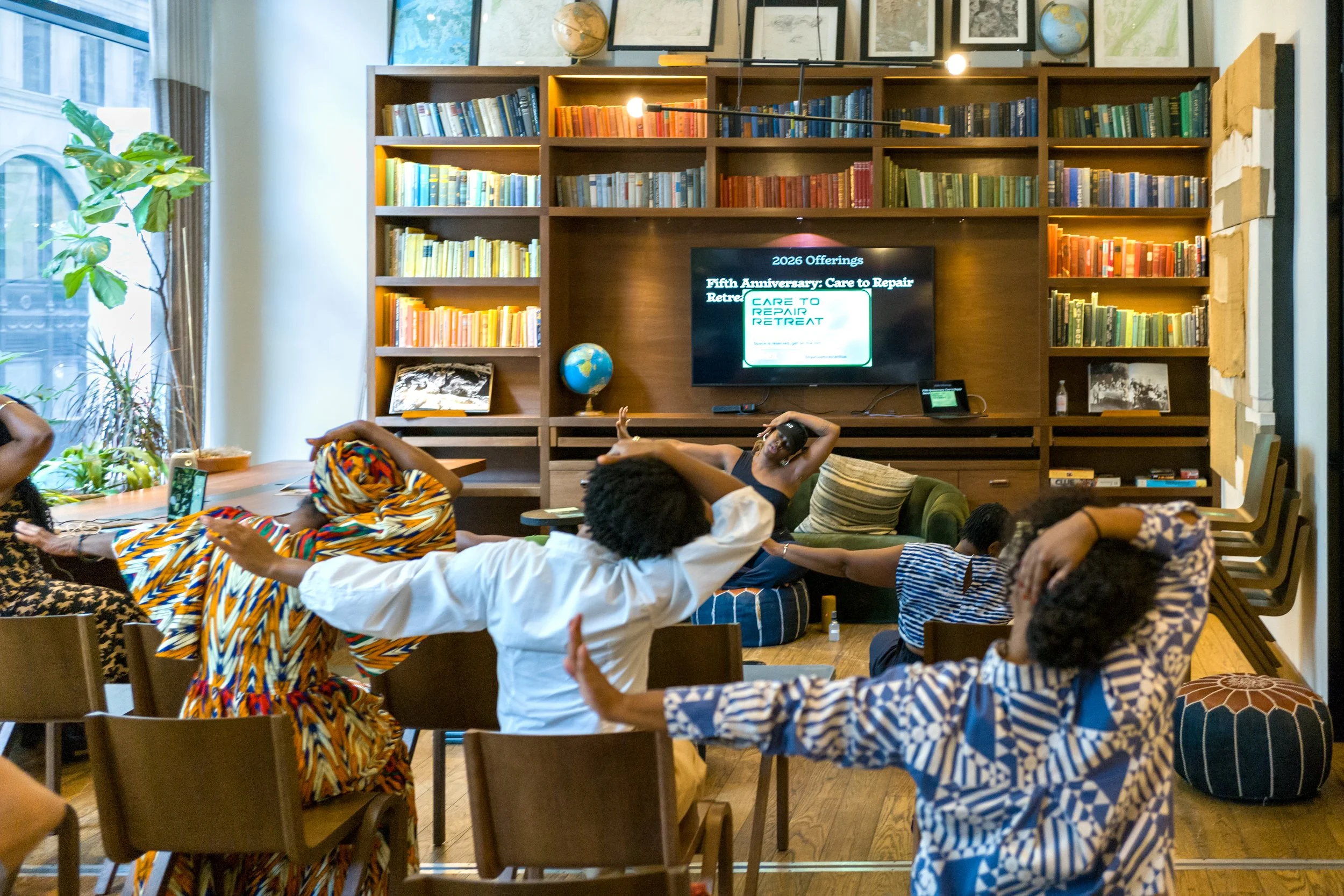 A group of humans stretching in a seated position,
