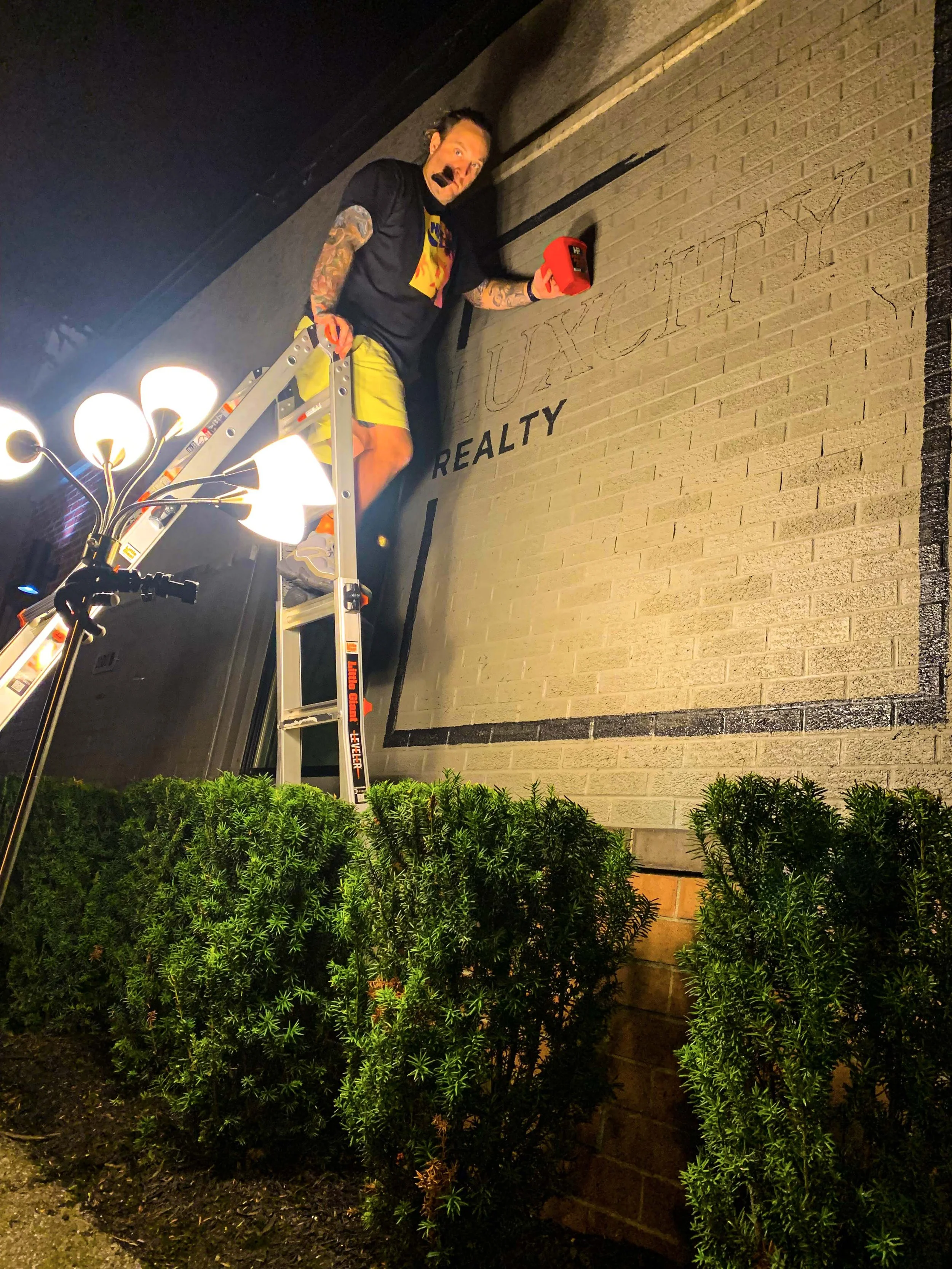 The process of painting LUXCITY Realty Mural.