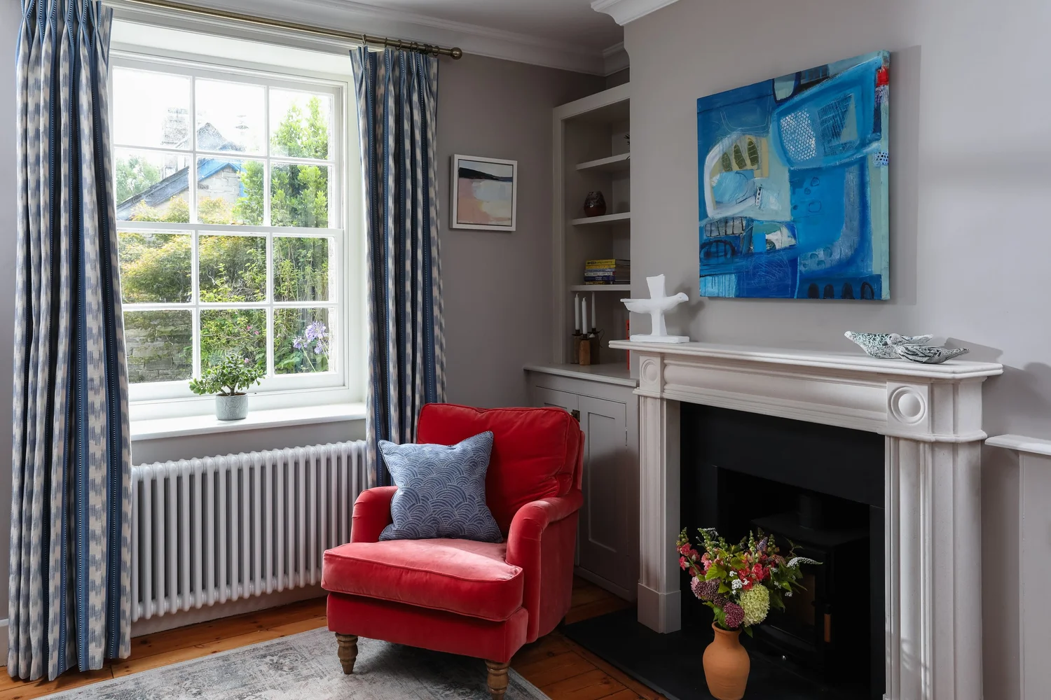 Red armchair by a window at Coastguard Cottages, St Agnes, photographed by Pip Hambling
