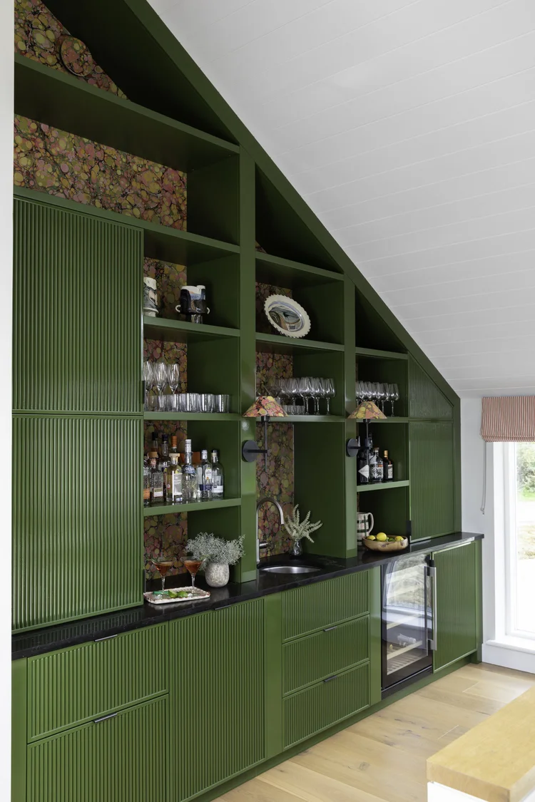 Green reeded bar cabinetry by The Coast Creative