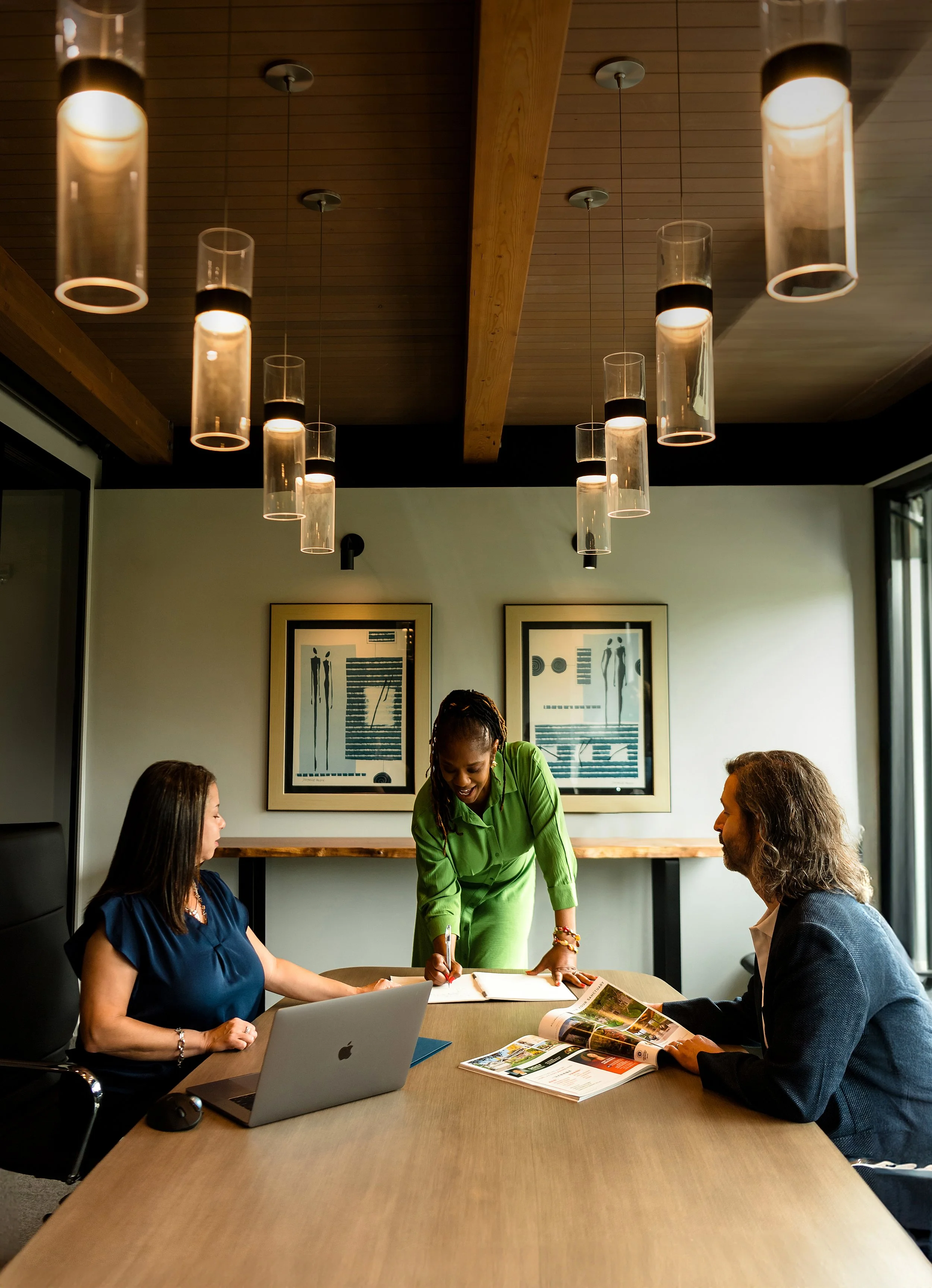 Windermere real estate team branding of three people in a modern office