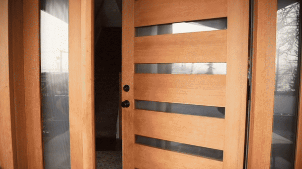 Wall portrait design. Wooden front door with horizontal glass panels, partially open, surrounded by wood framing and glass side panels.