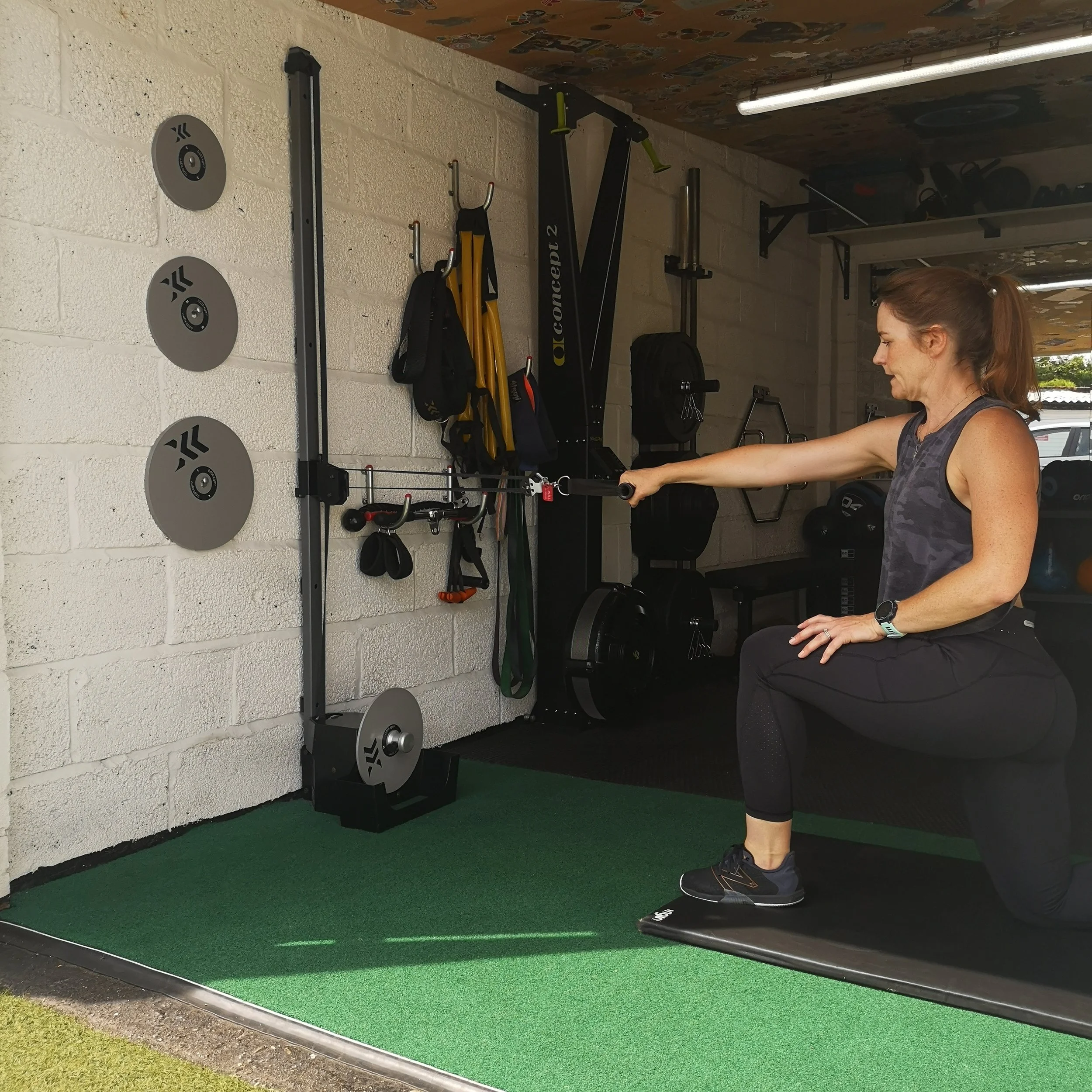Personal trainer coaching a client in a private gym in Shepperton.