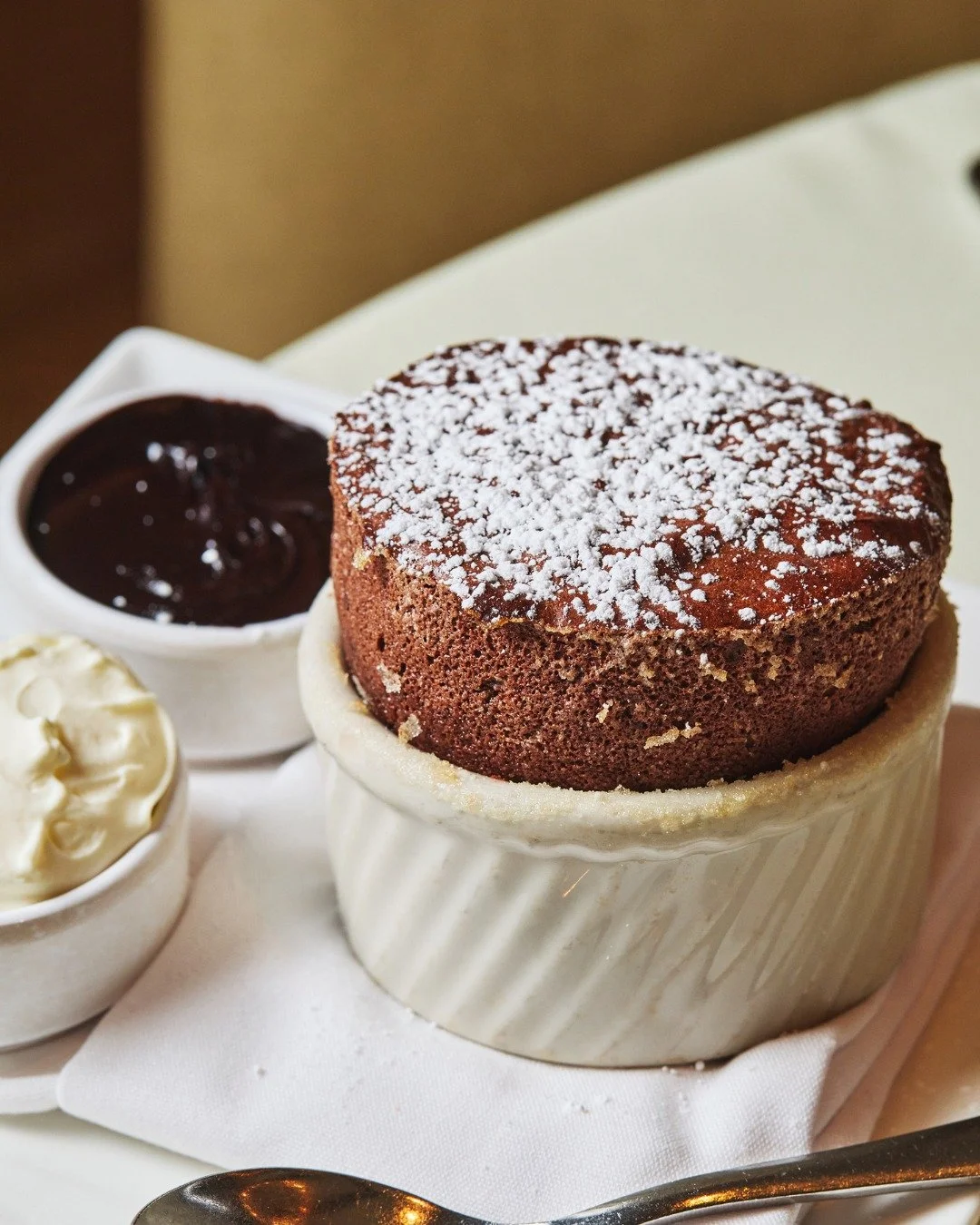 An enduring classic: our chocolate souffl&eacute;, served warm from the oven with chocolate sauce and chantilly.

📸 @briansamuelsphotography