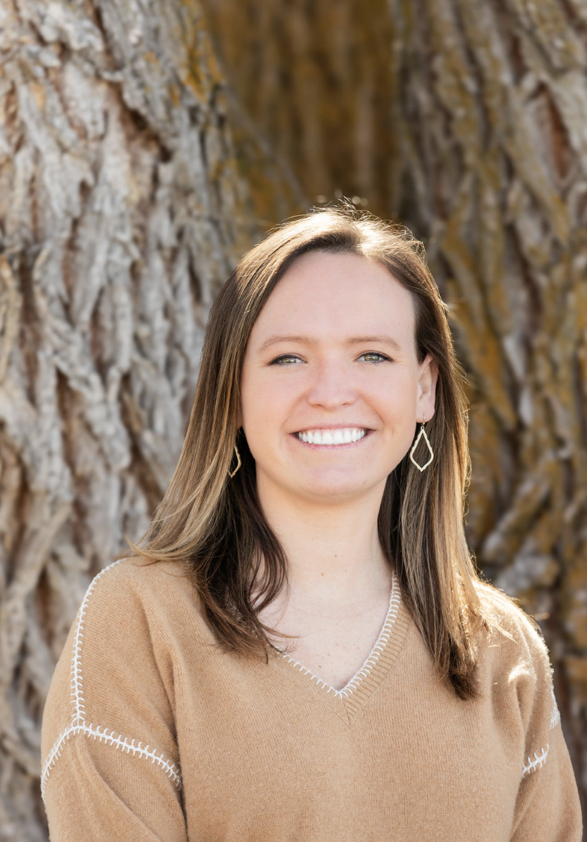 Headshot of therapist with tree in background