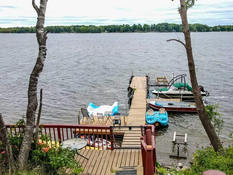 Dock with boats on an Ontario lake in late summer