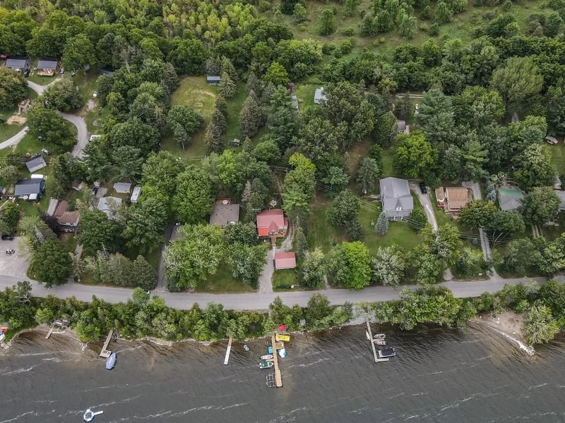 Aerial view of a shoreline road and waterfront properties in Ramara, Ontario