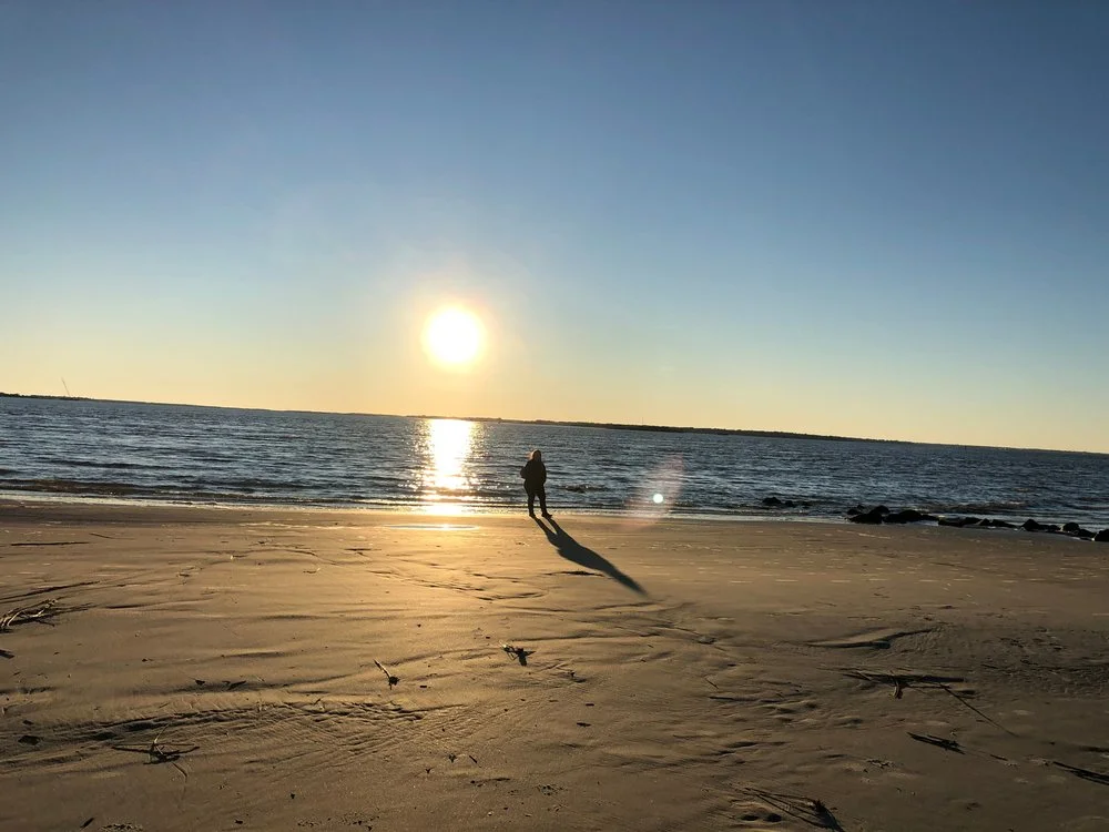 A person walking along Sullivan's Island Beach