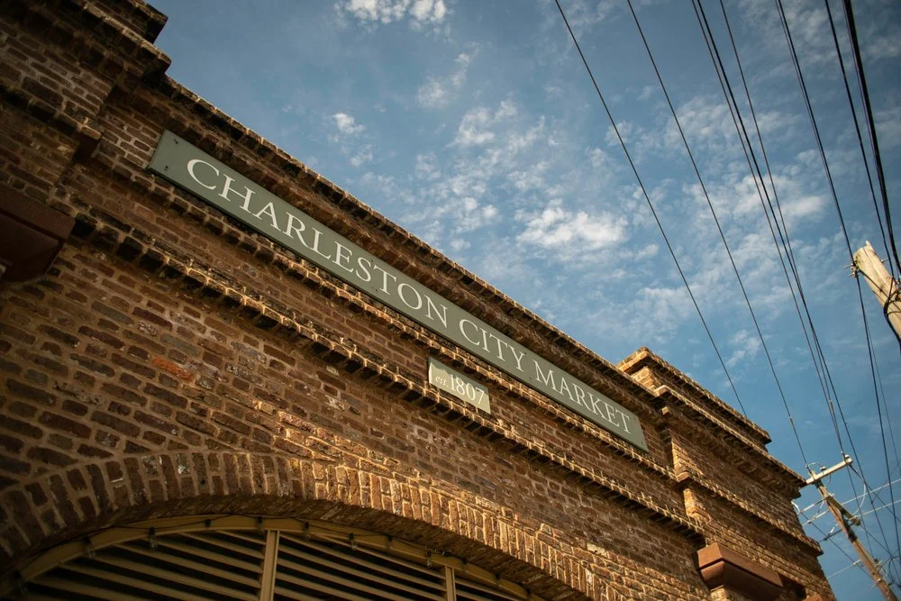 The Charleston City Market signage displayed on a brick arch