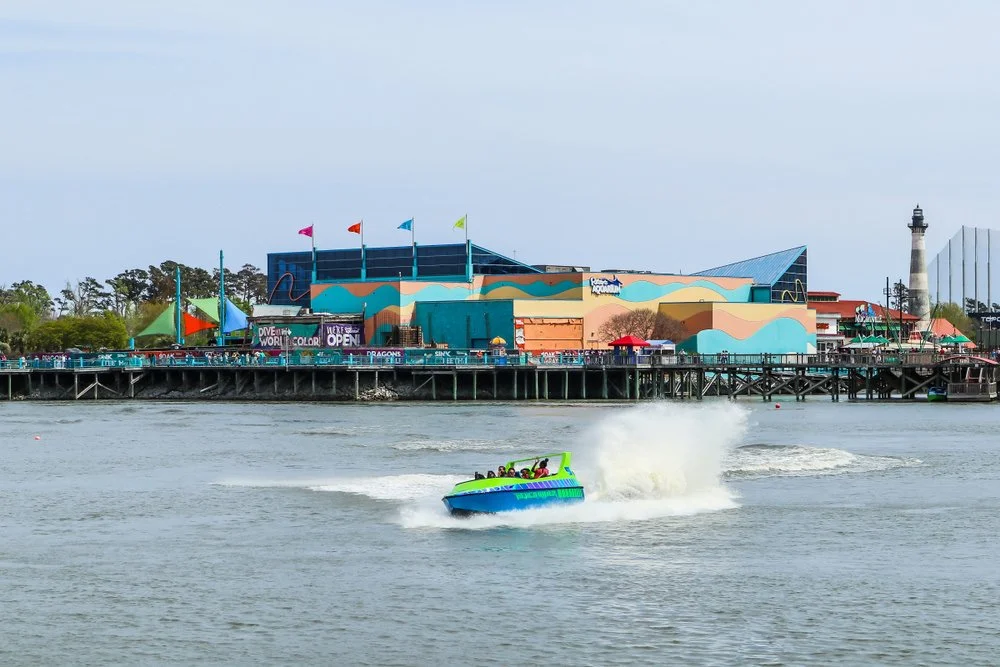 A jet boat ride provides an adrenaline rush for passengers at the Broadway at the Beach entertainment complex, with Ripley's Aquarium in the backdrop