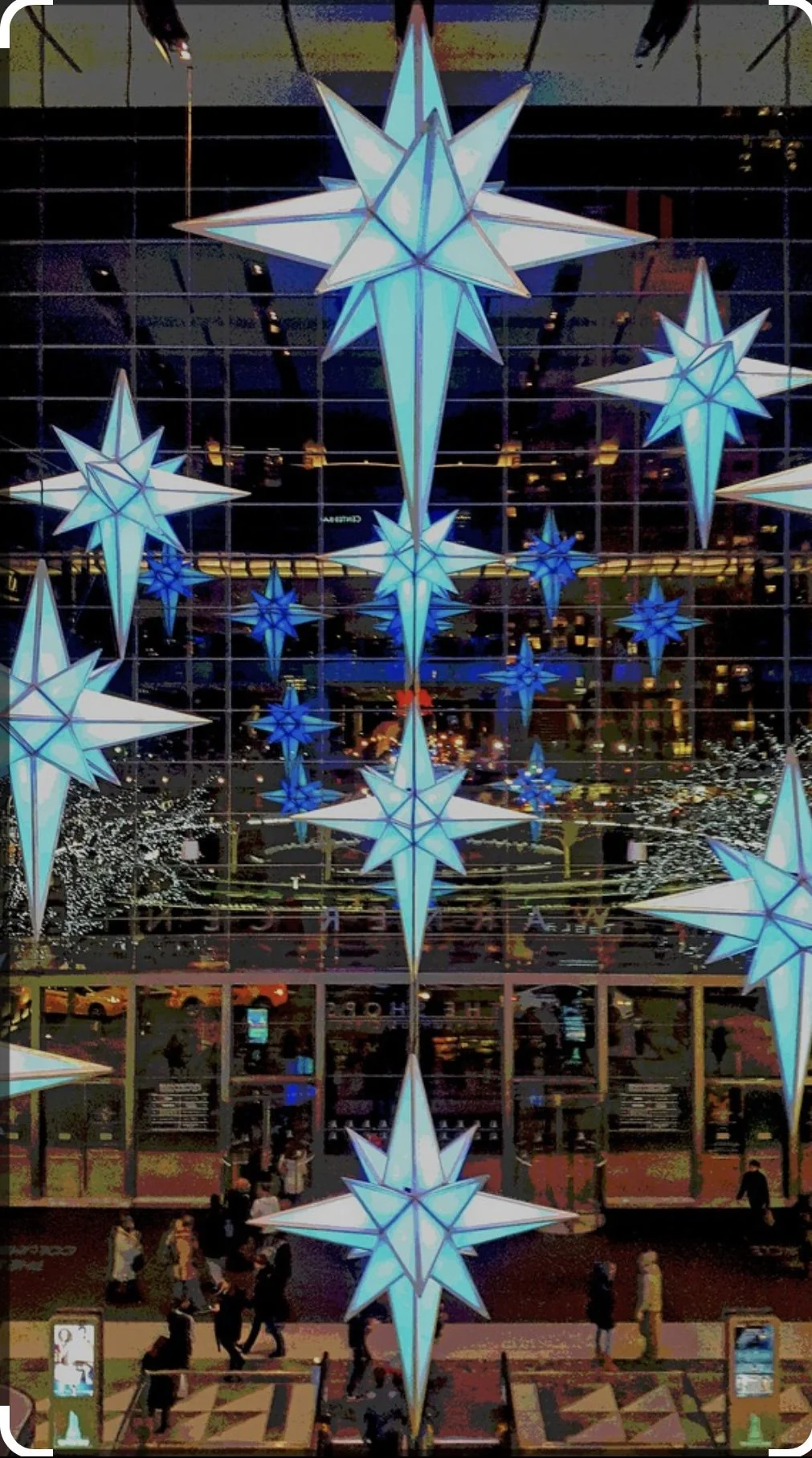 Suspended illuminated star installation in a retail atrium