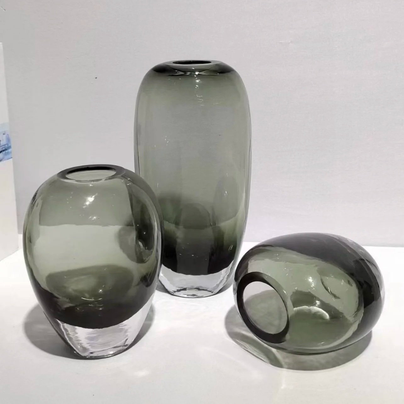 Traditional Glass Vase in various shapes and colors for retail visual merchandising display, produced by Schwam Sourcing Group.