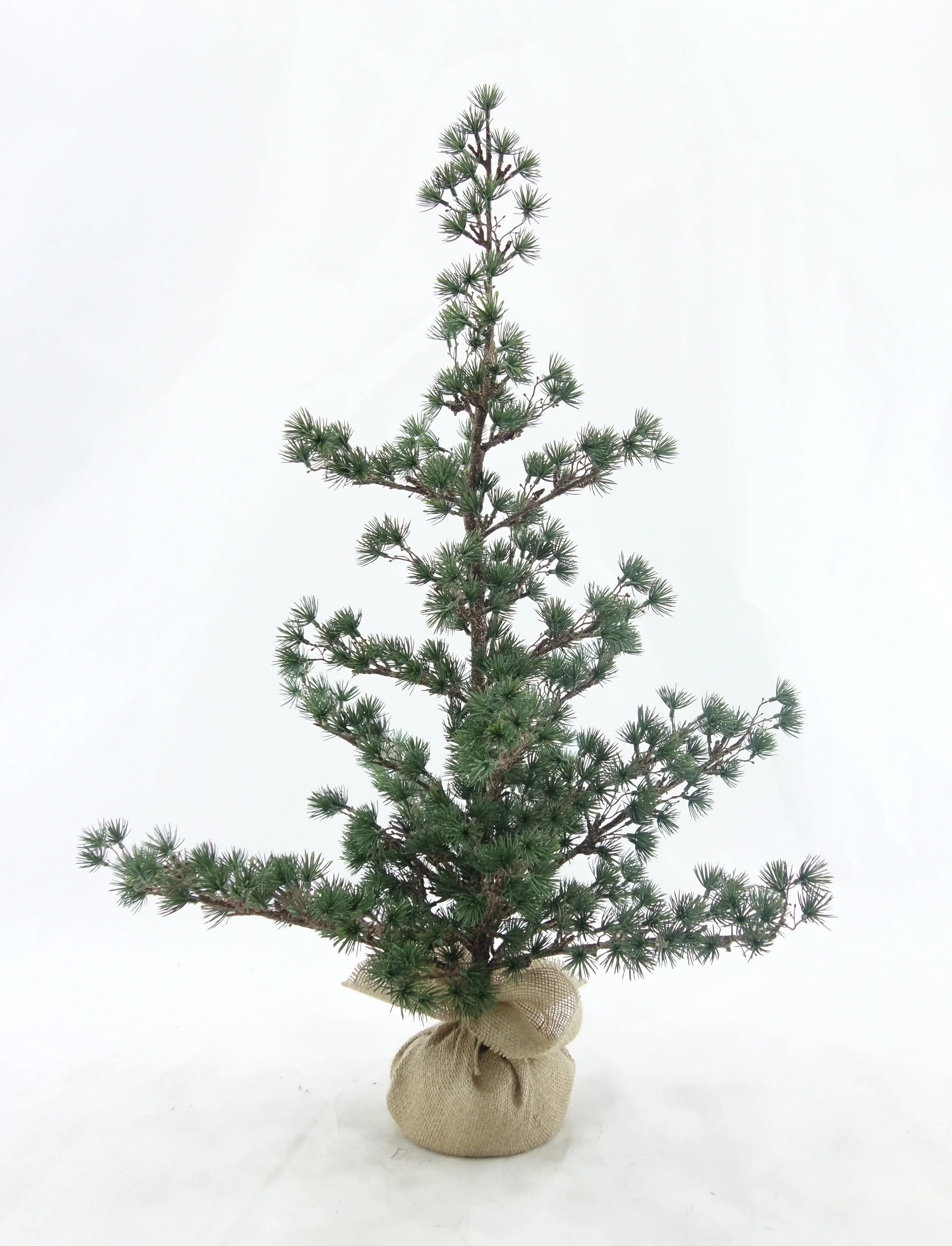 Decorative faux Christmas trees with green branches and led lights for retail visual merchandising seasonal in-store displays, produced by Schwam Sourcing Group
