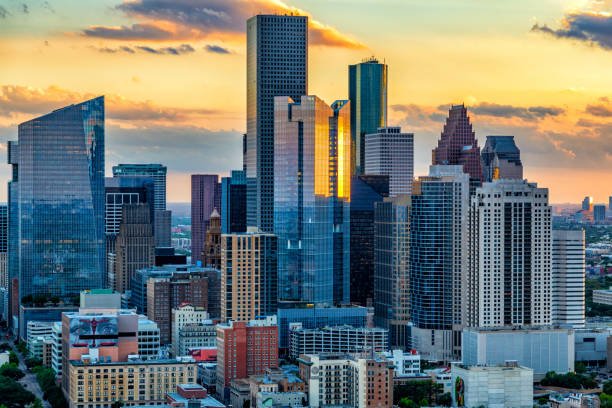 Skyscrapers and high-rise buildings in downtown Houston at sunset.