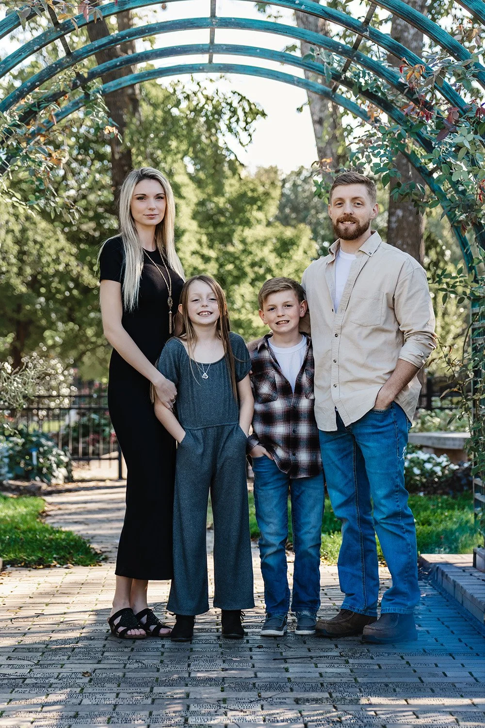 family of four posing for summer family photos at nathanael greene in springfield mo