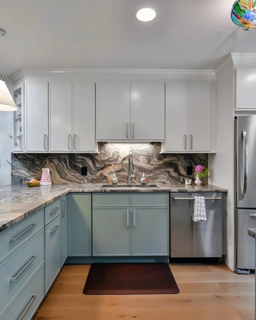 The heart of this complete condo renovation was creating a kitchen that truly serves as the centerpiece of daily life. We transformed a non-functional space into a sophisticated coastal kitchen with a stunning quartzite slab from ABC Stone and simple