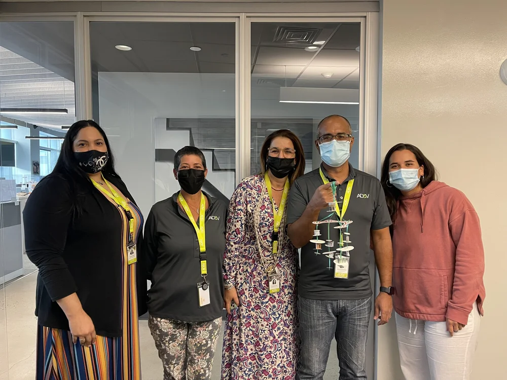  AD&amp;V team members posing for pictures 