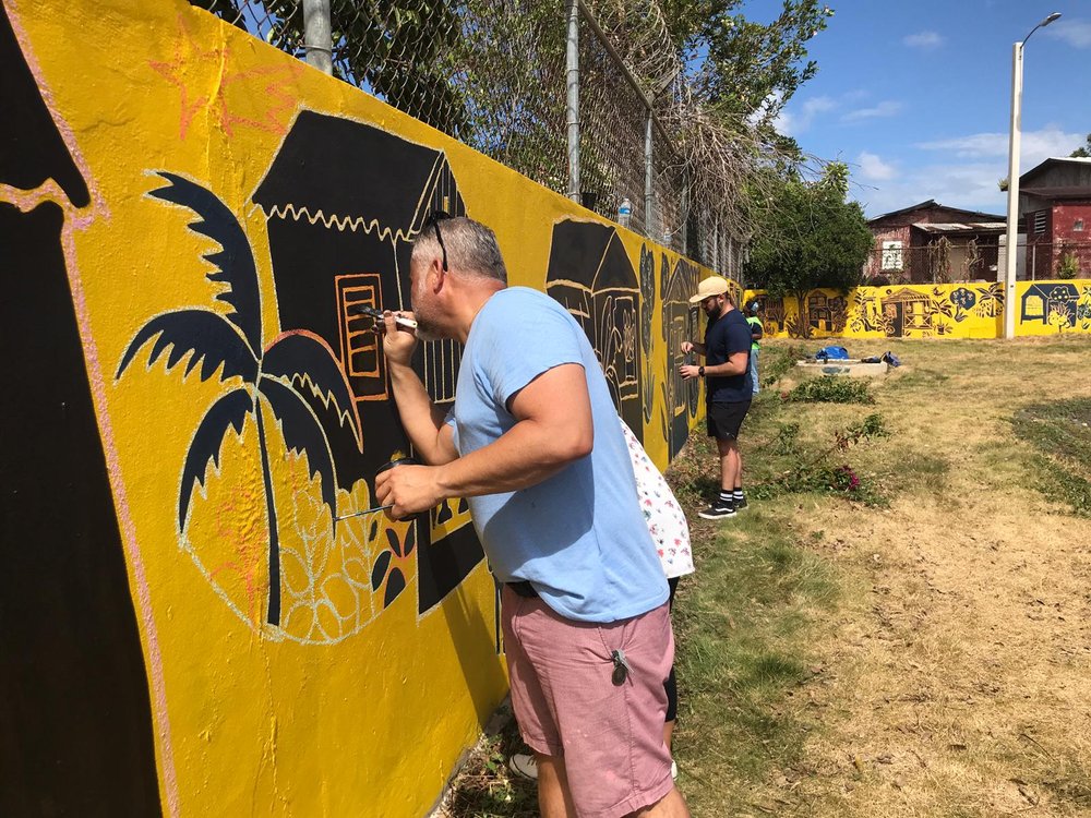  AD&amp;V team member painting mural 