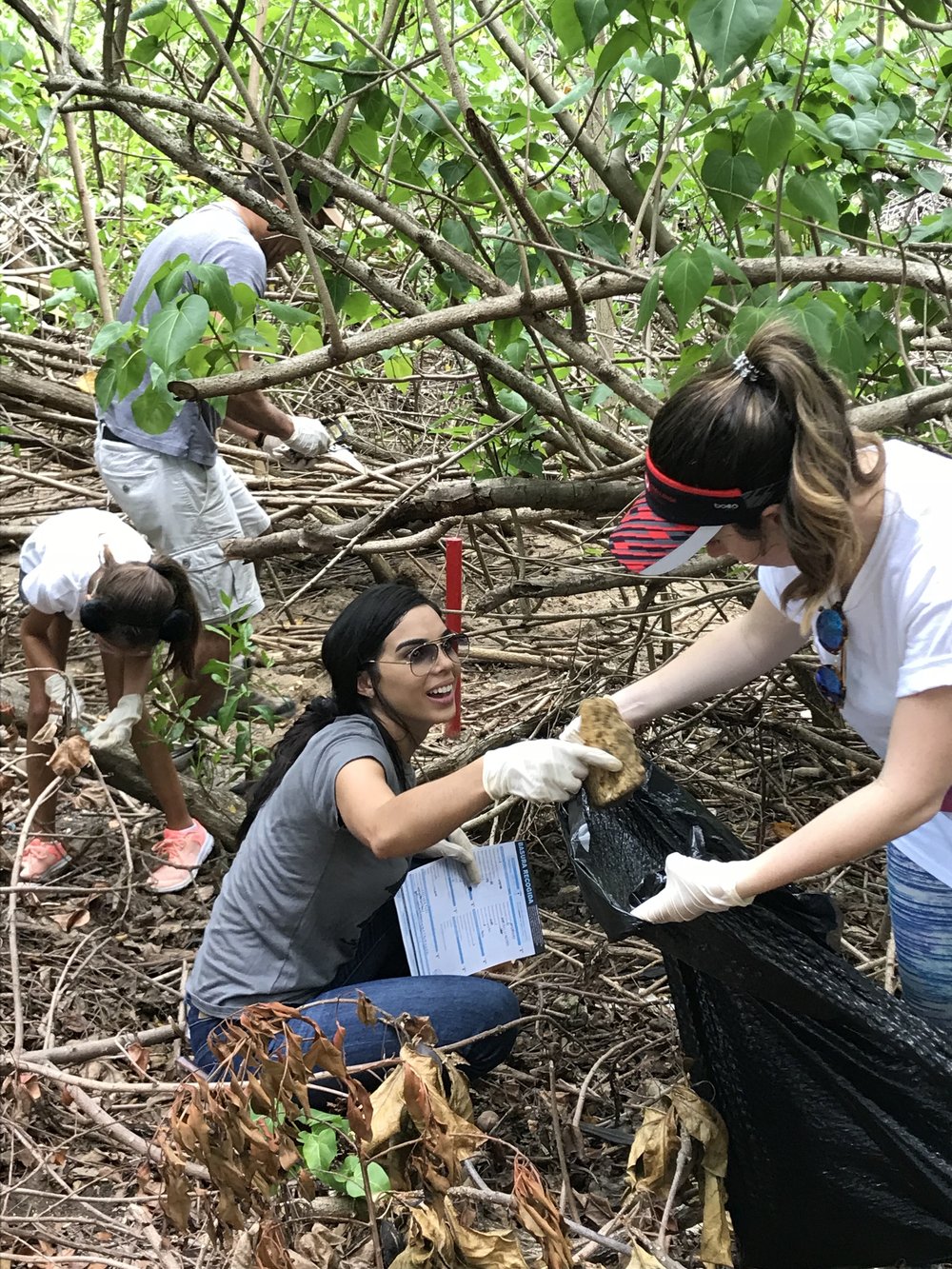  AD&amp;V team member and family picking up trash for cleanup 