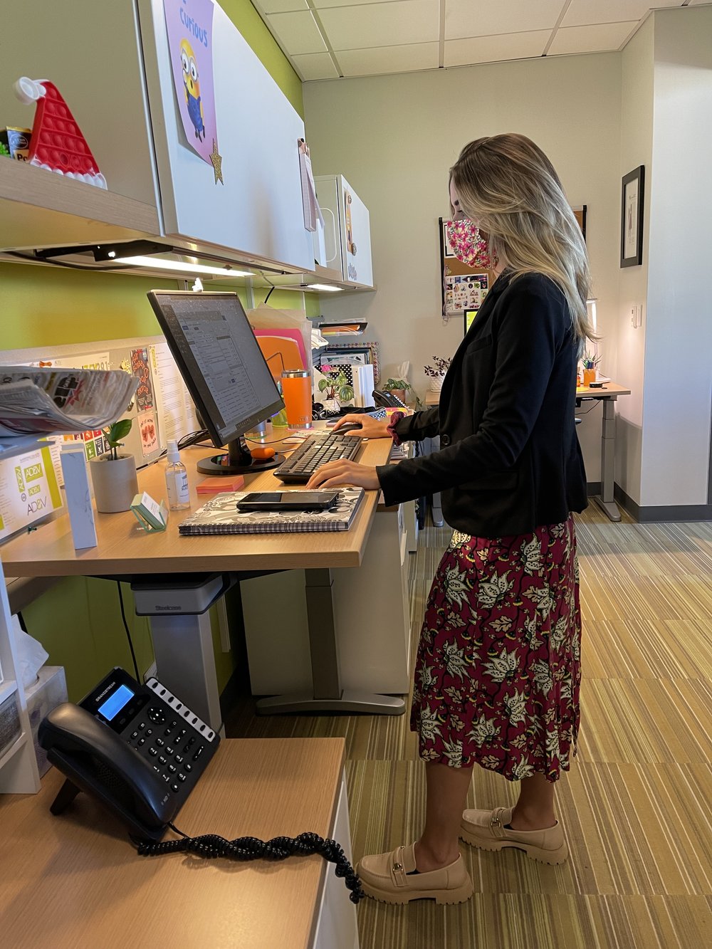  AD&amp;V team member working on standing desk 