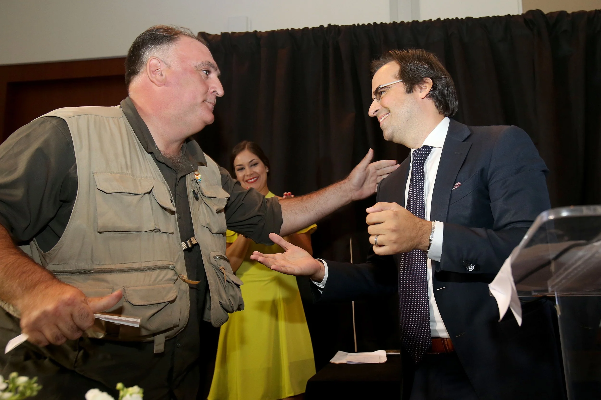 AD&V's ceo shaking hands with industry leader at a conference.