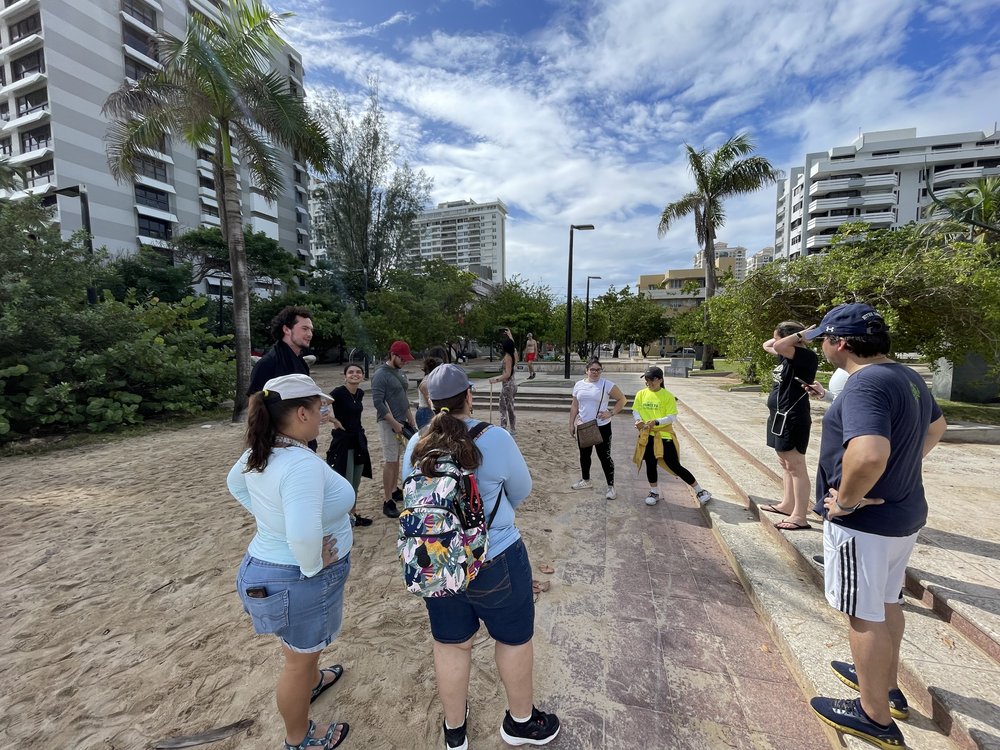  AD&amp;V team members picking up trash at a local beach. 