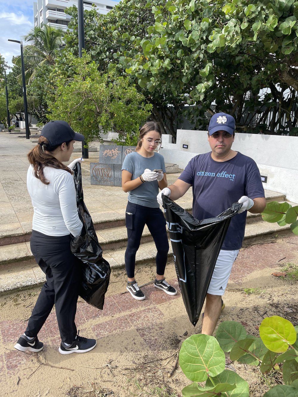  AD&amp;V team members picking up trash at a local beach. 