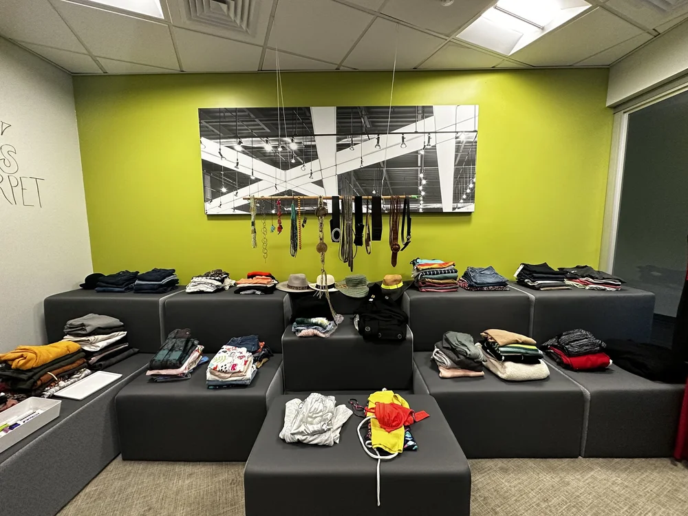  Clothes placed in the AD&amp;V green carpet thrift shop. 