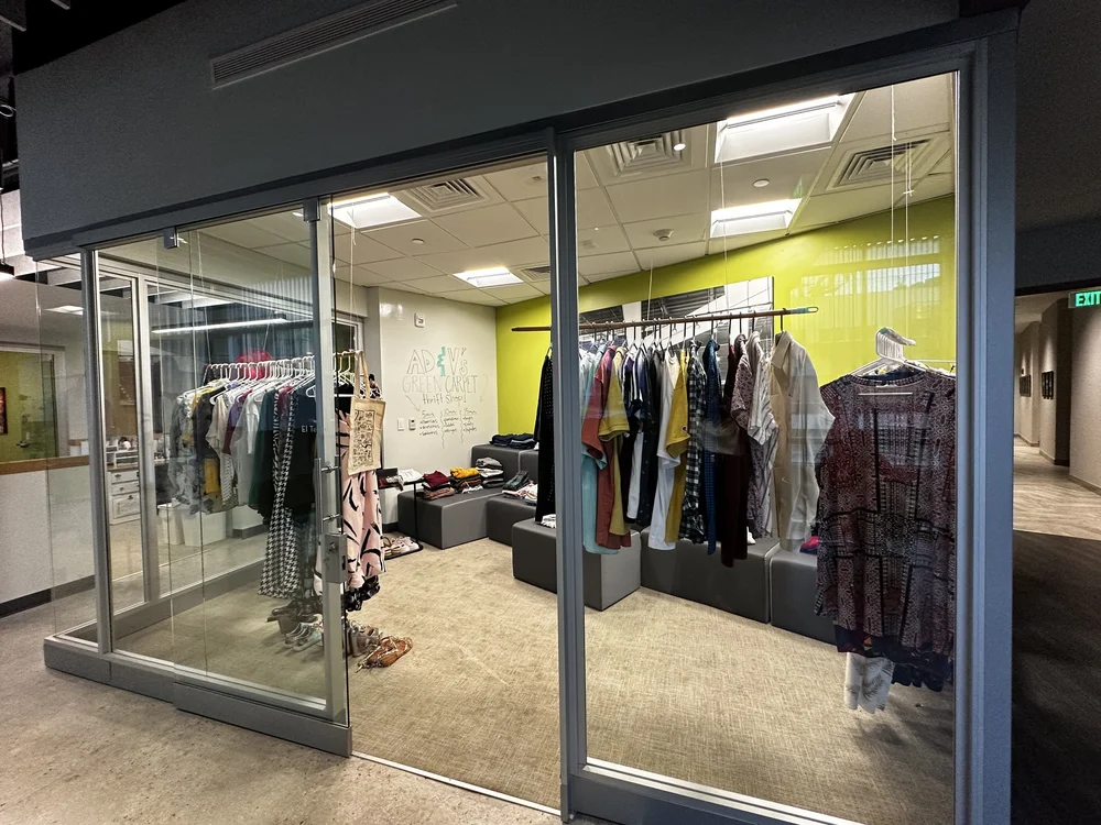  Clothes placed in the AD&amp;V green carpet thrift shop. 