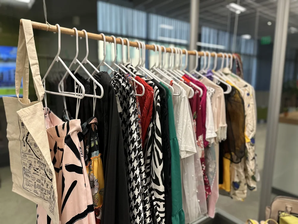  Clothes placed in the AD&amp;V green carpet thrift shop. 