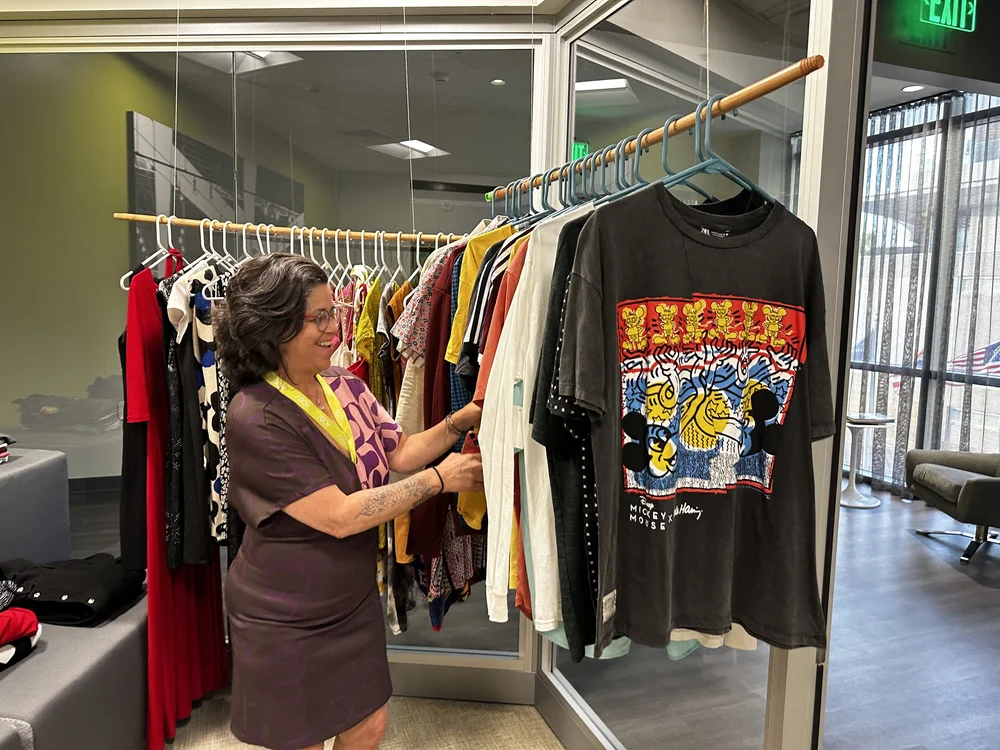  AD&amp;V team member looking through the AD&amp;V green carpet thrift shop. 