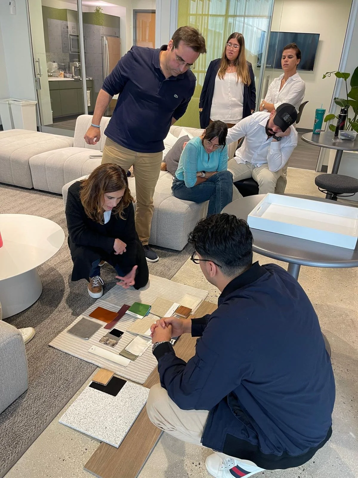 Interior Design team discussing materials board.