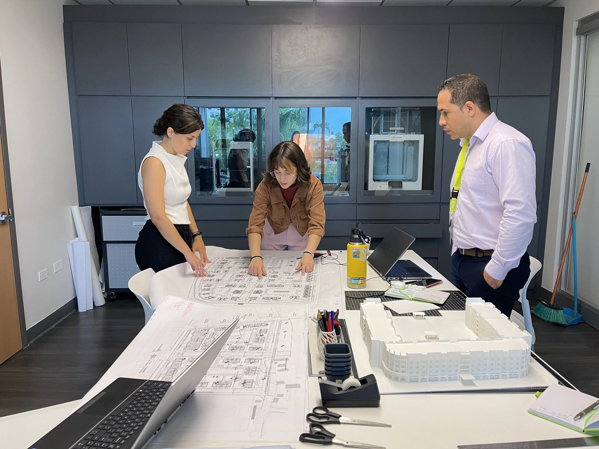 Intern and AD&V team members working on project models.