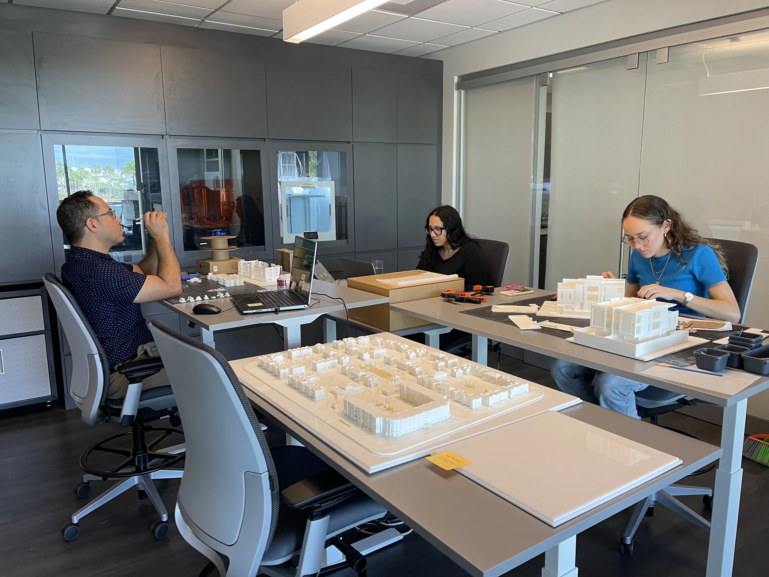 Interns and AD&V team member working on project models.