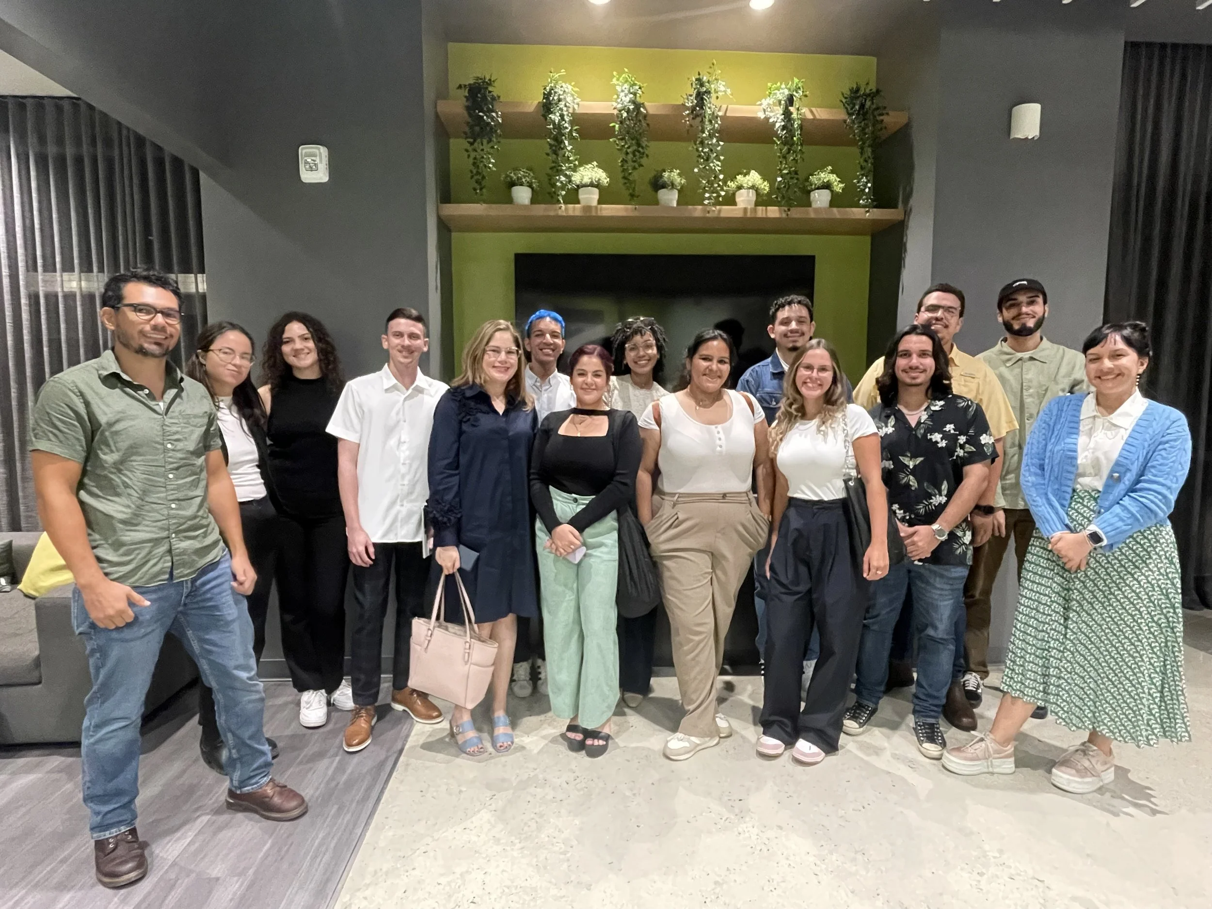 AD&V team member posing for a picture with a group of students.