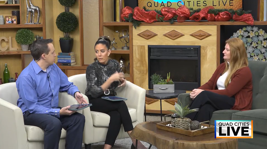 An image of two people from KWQC and Emily Cummings sitting in chairs, having a conversation.