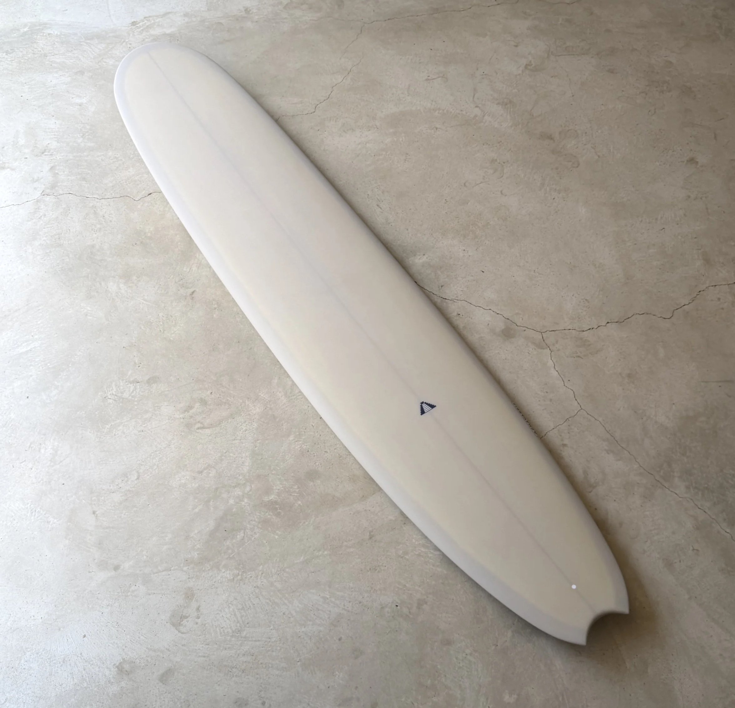 Champagne custom longboard with a small pyramid logo on the  deck of the surfboard made in Sayulita, Mexico