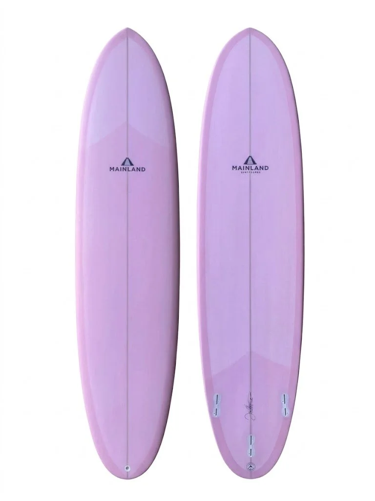 A pink surfboard with floral and bird artwork on the top side and a plain pink bottom side.