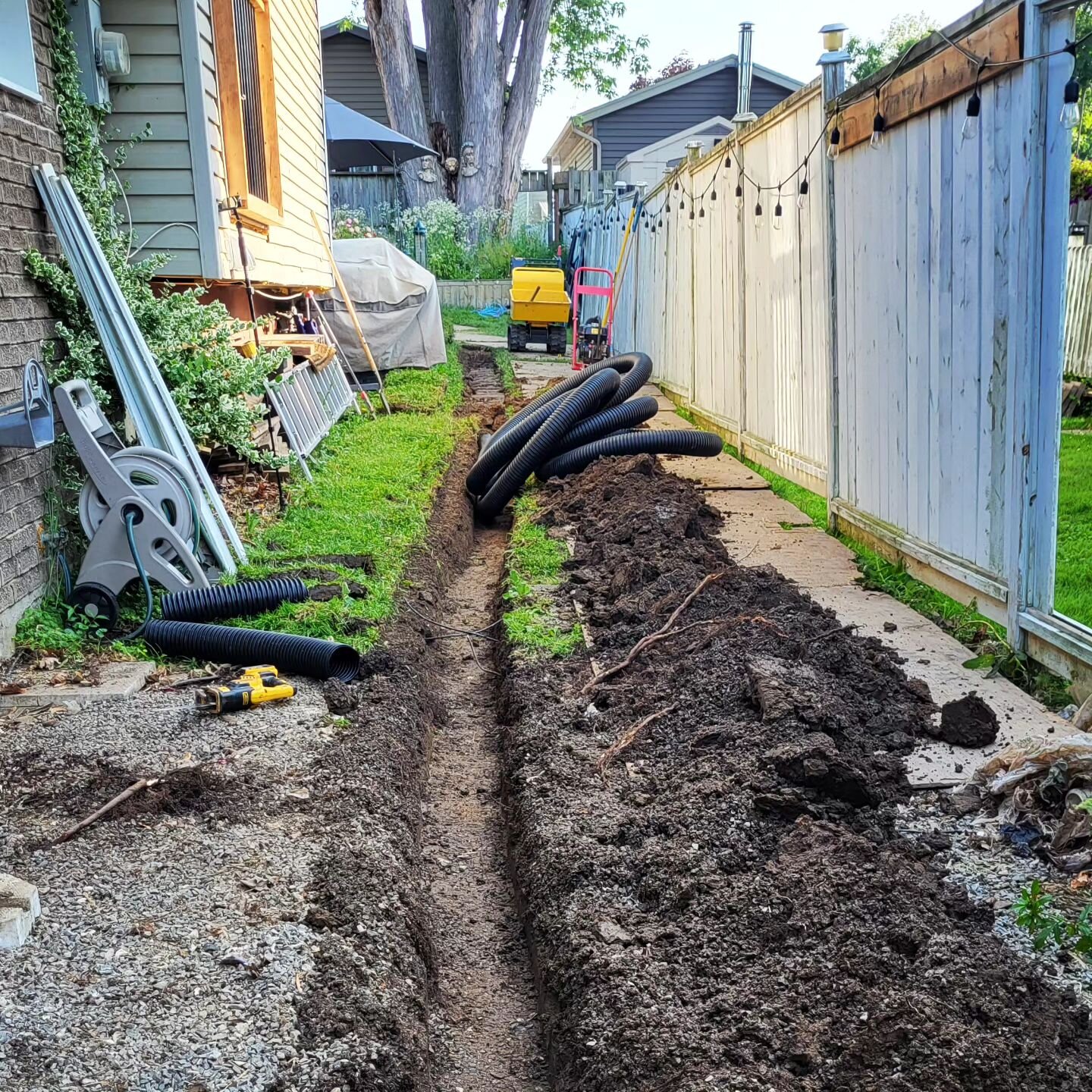 Rain...heat....repeat. This home got a French drain and buried downspouts in preparation for a fence install. We closed the job and staged next door for another job. We love the back to back jobs! #employeeappreciation #heatwave #customerexperience #