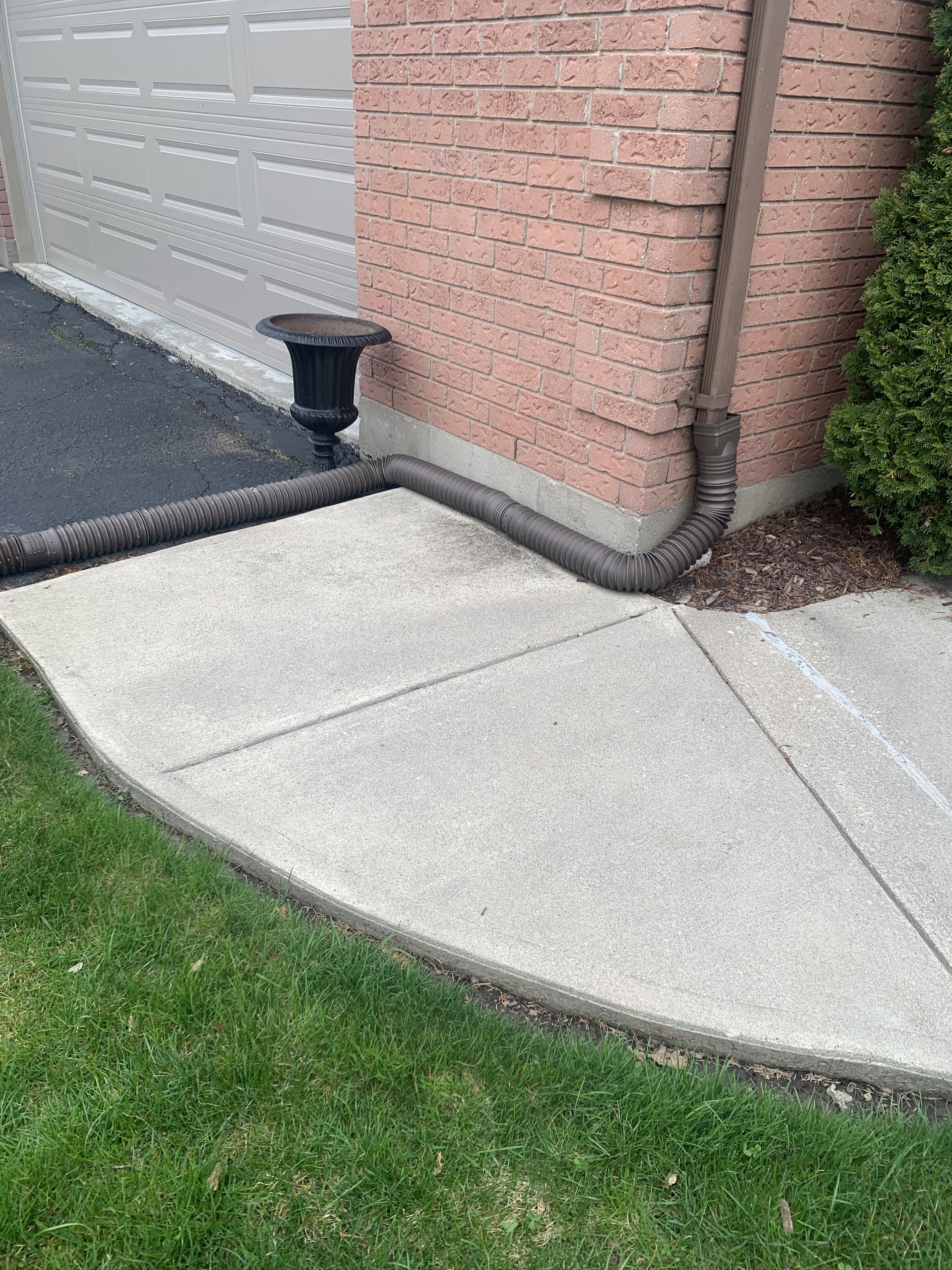 downspout close to walkway