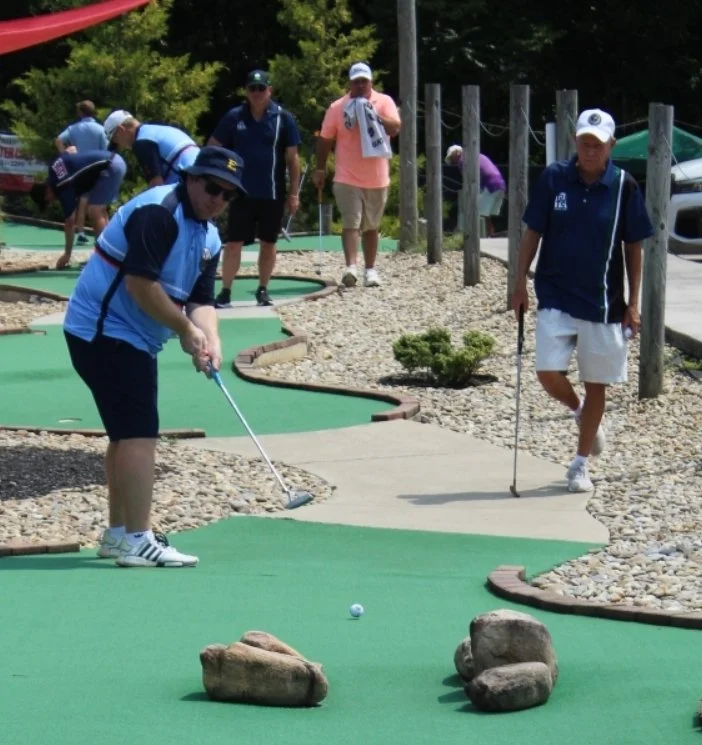 Joey Baldasano (Johnson City, TN) takes an aggressive line through the rocks on hole 17 while Gary Hester (Calabash, NC) watches on