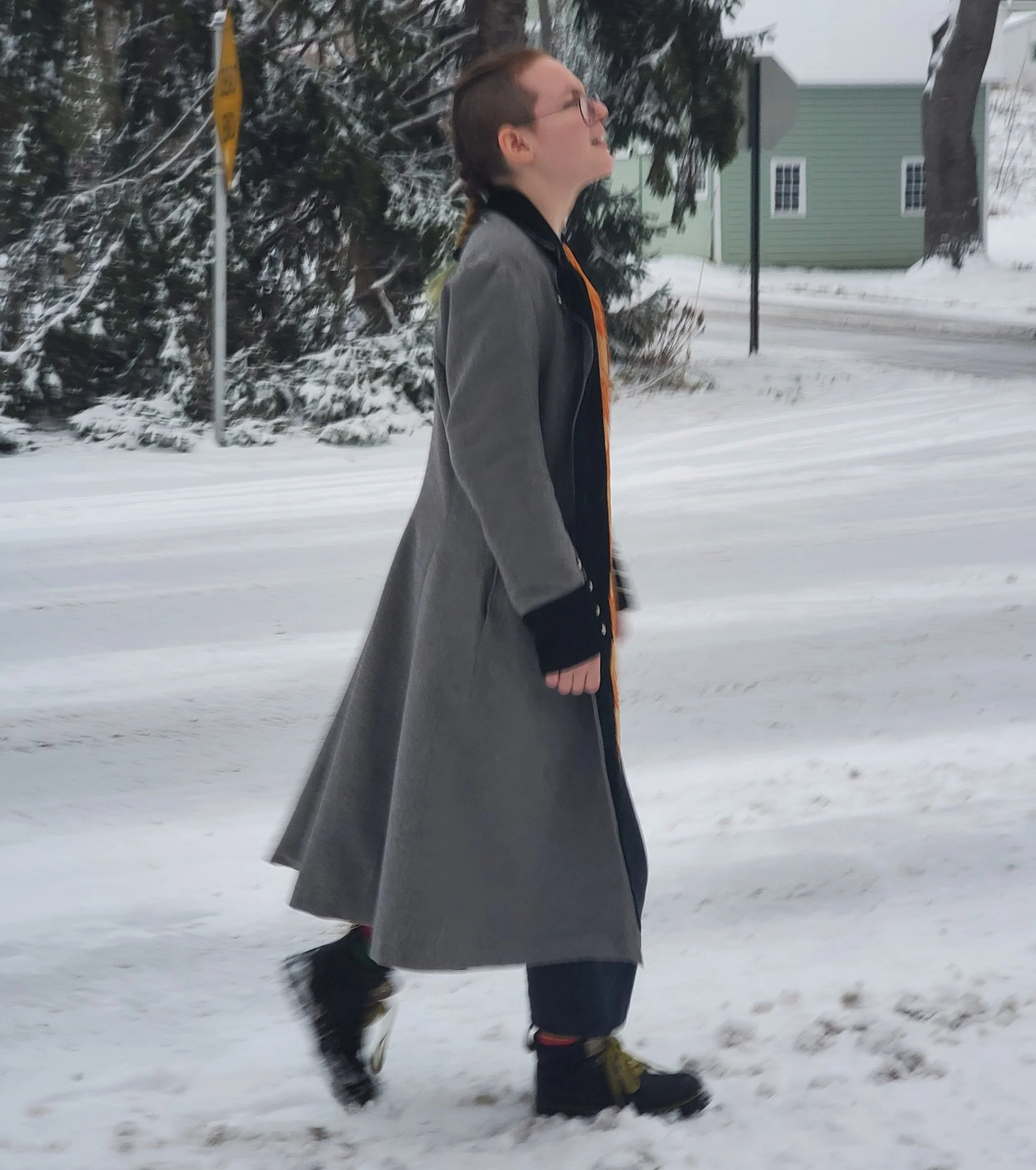 It closes in the front with three buttons and a cloak clasp, and has large pockets.