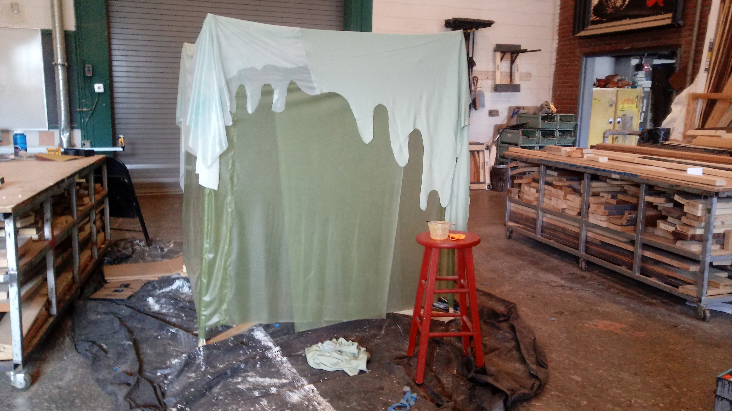 After wrapping the cube frame, and using contact cement to adhere it to the frame, I draped and cut other green stretch fabric to create a top to the cube.