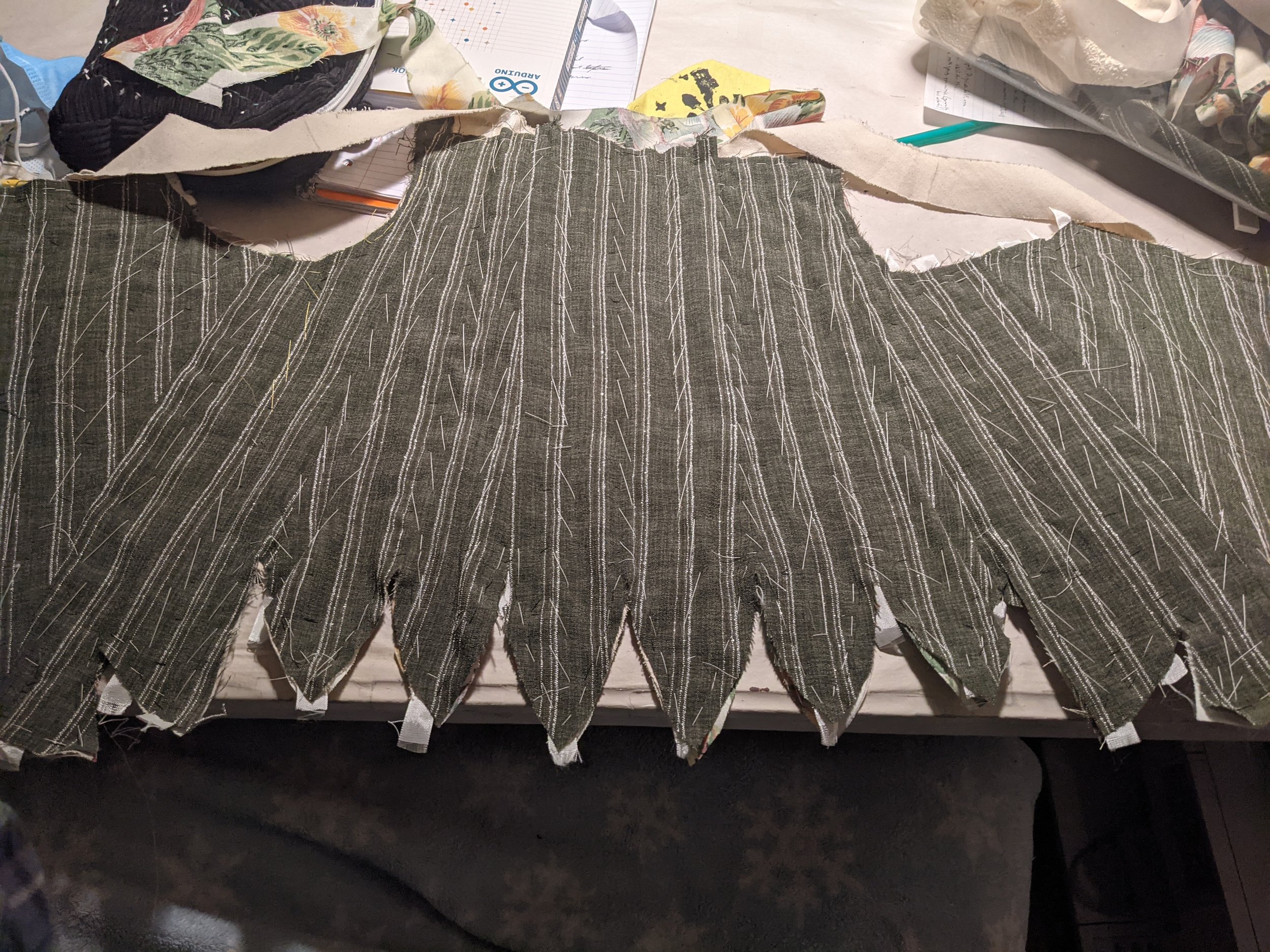 I then pad stitched both layers of fashion fabric to the interlinings before binding the edges to keep it secured.