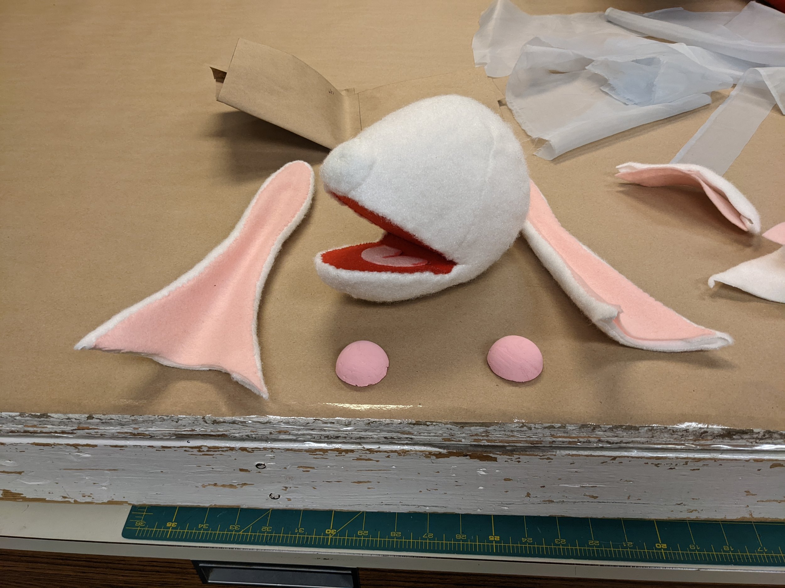 I shaped the ears from foss-shape, then wire stitched the wire frame on. I covered them in puppet fleece and felt. I also covered the head in felt, and added another shape to define the nose.