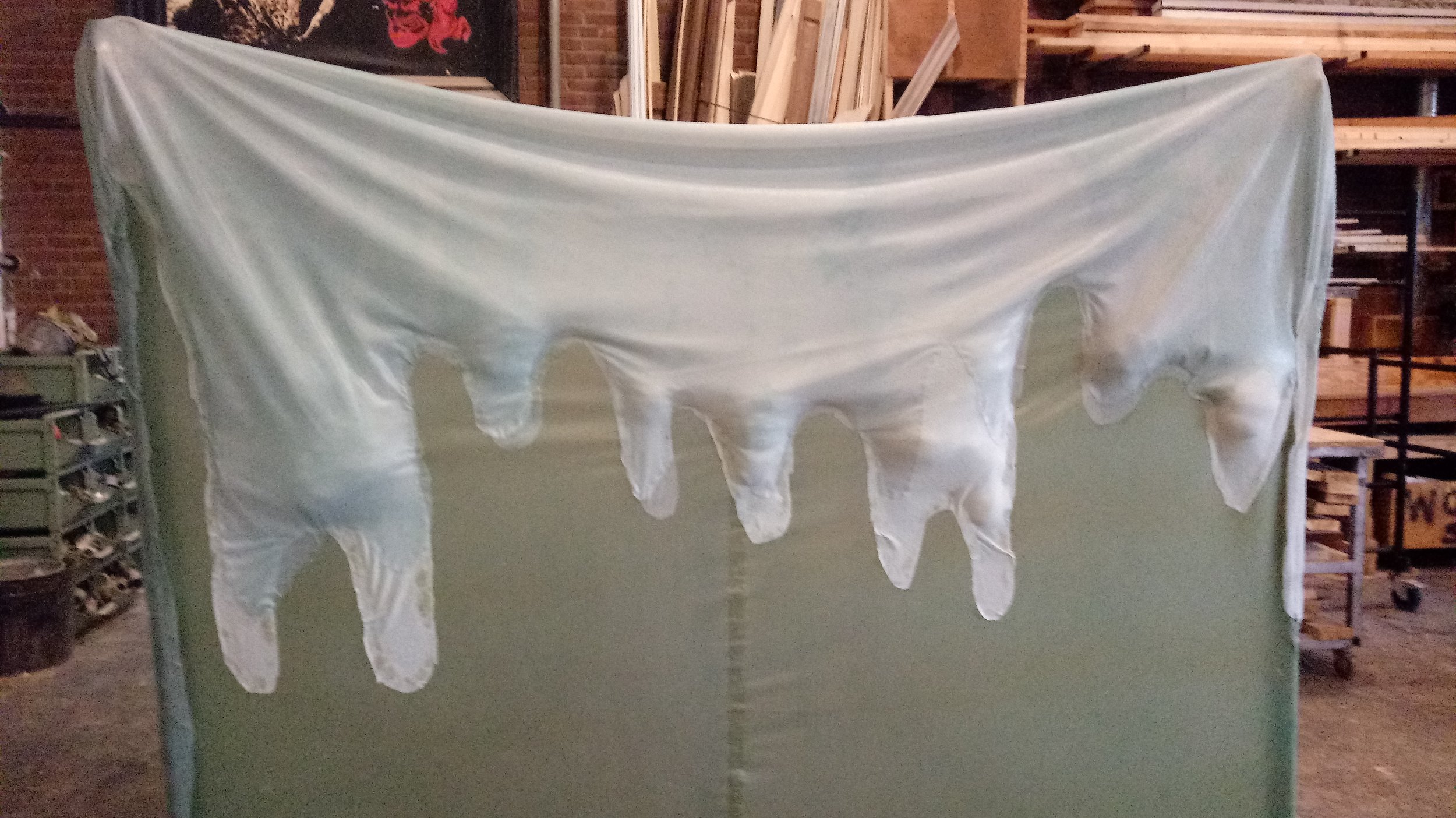 After adhering the fabric drips to the latex, I stuffed the back of the drips to give it more texture and volume.