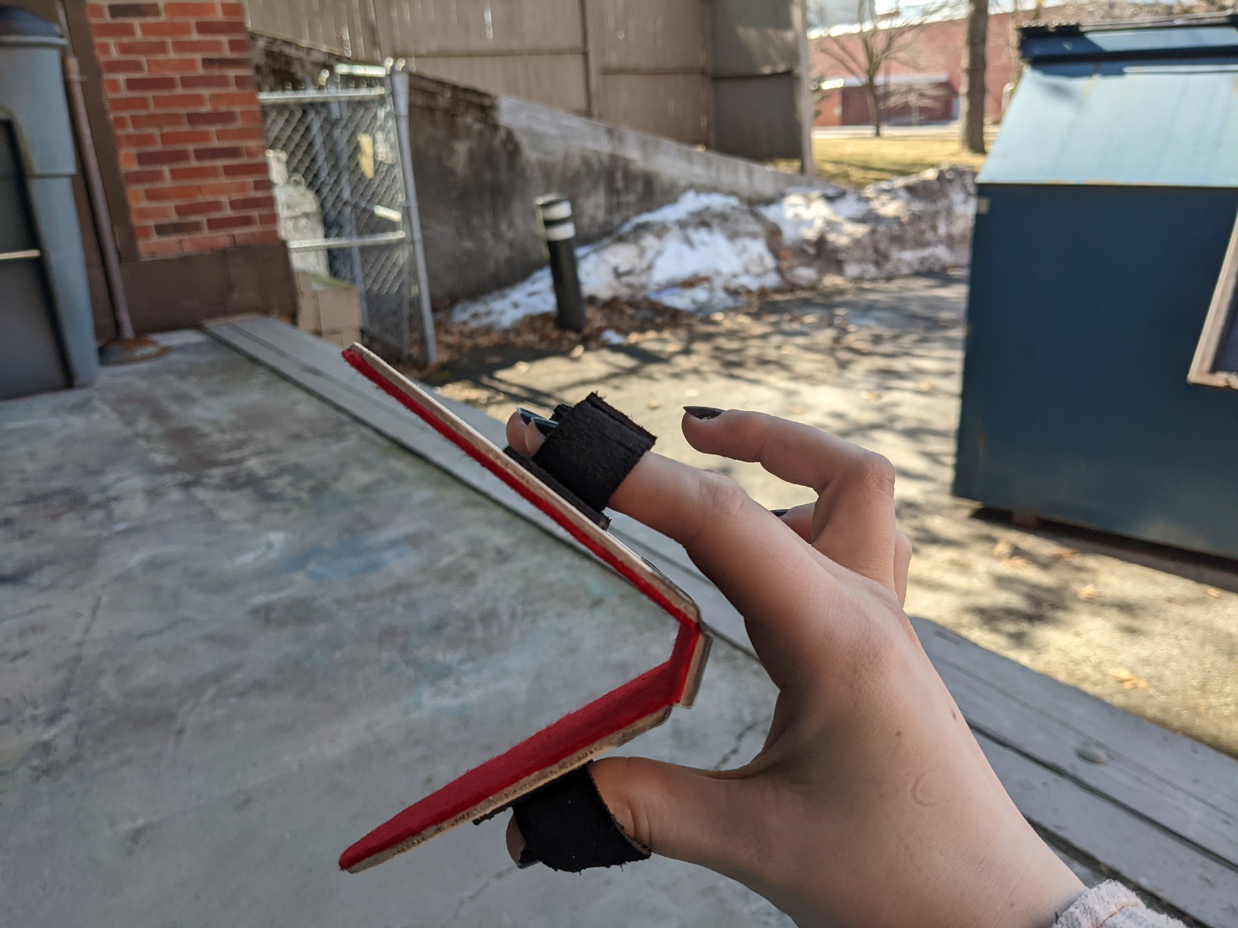 I made a mouthplate from 1/8" birch plywood, gaff tape, contact cement, felt, and leather strips.