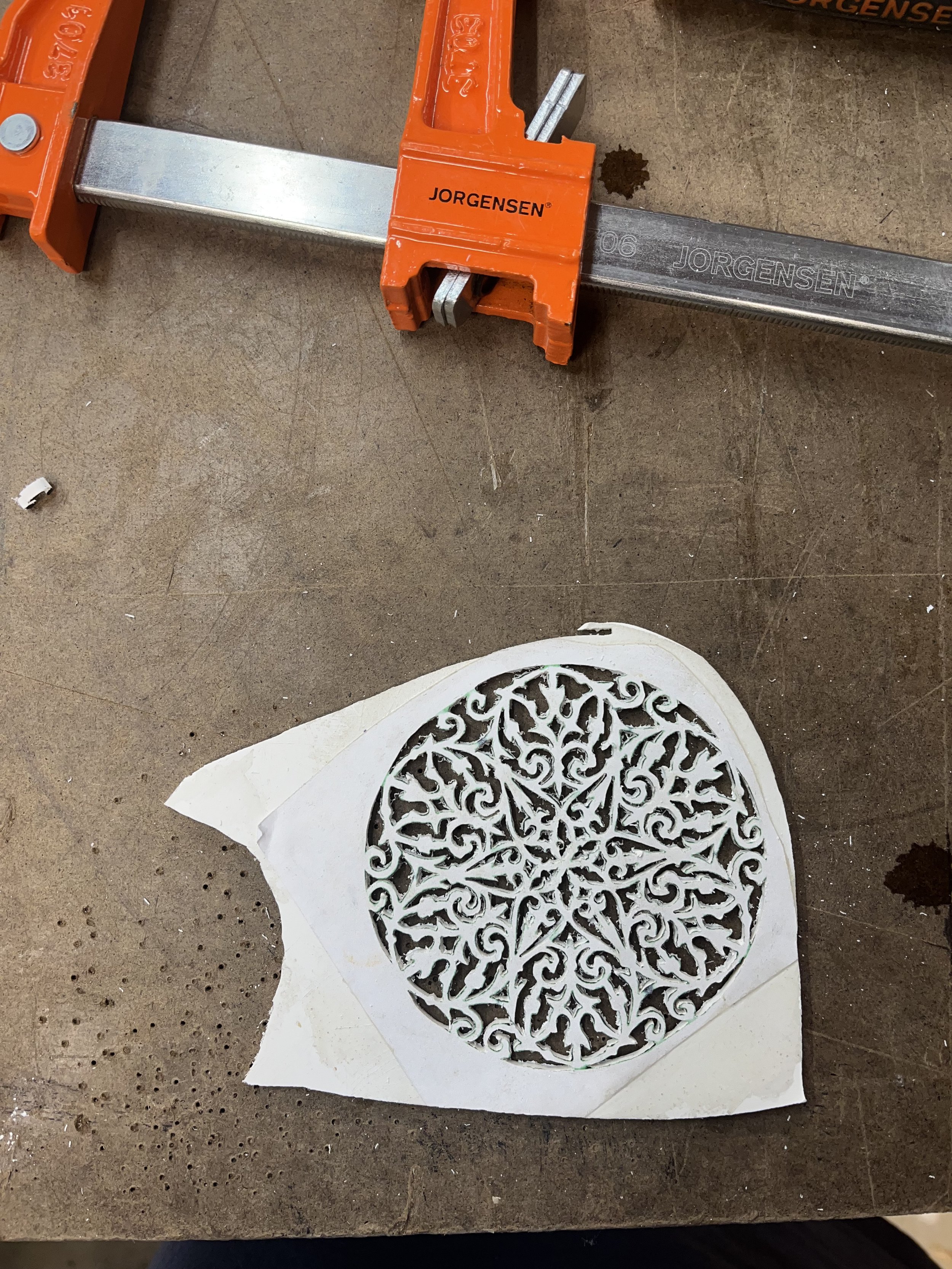 Creating a replacement rosette. We look for images of the instrument maker's previous work, so we can create period-specific replacement designs.