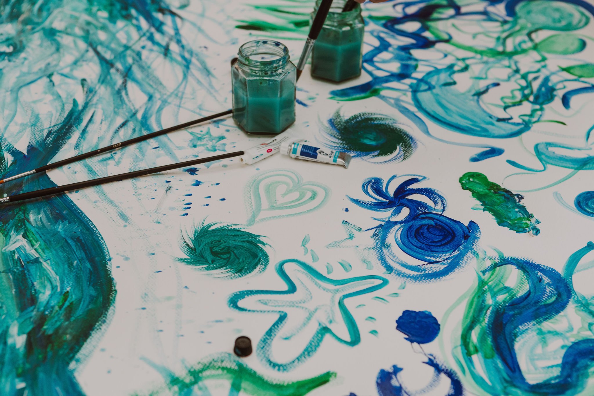 Close up of the water art and jars of blue paint.