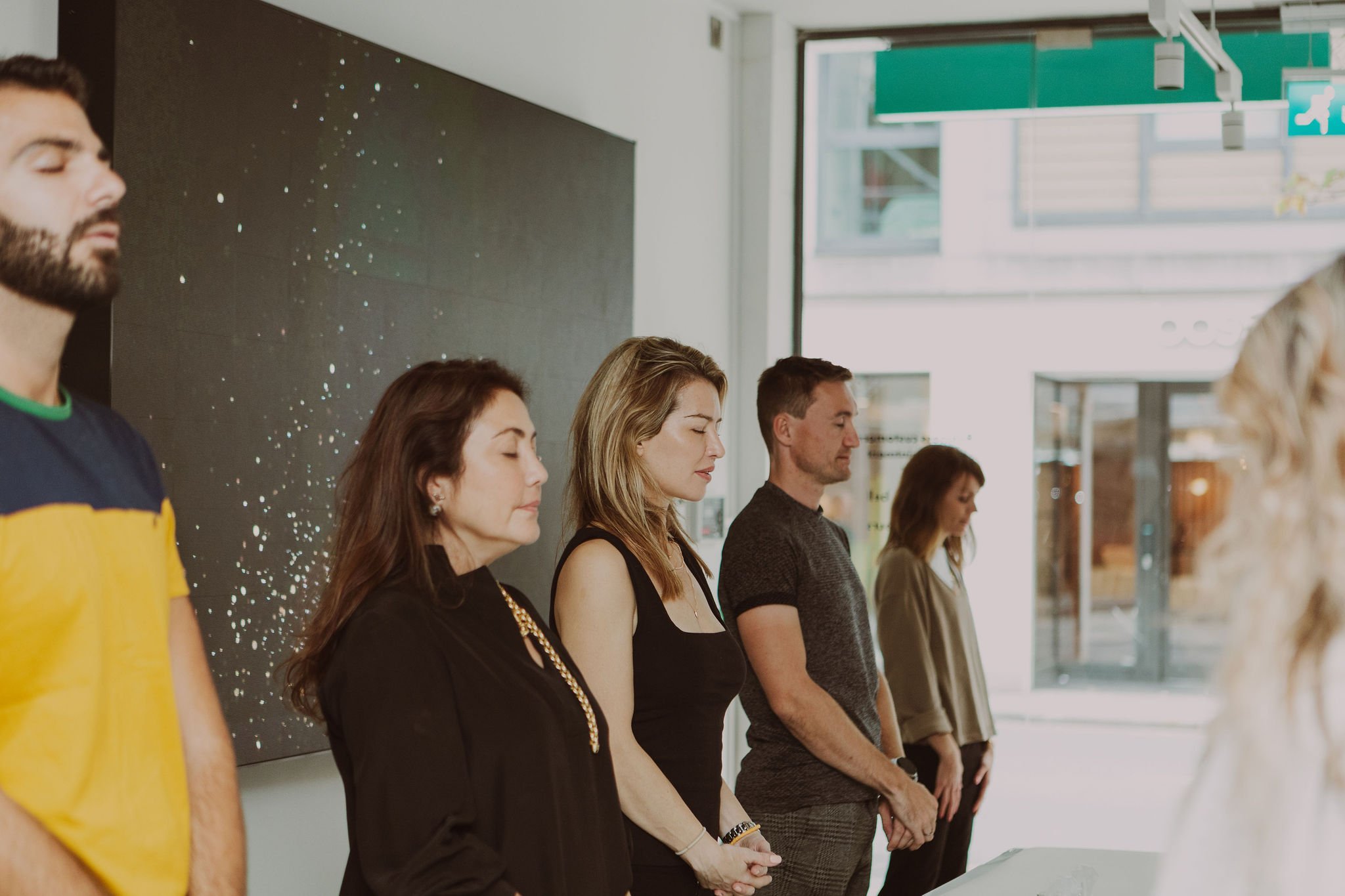Group at a workshop with their eyes closed.
